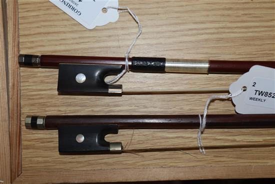 Two round stick violin bows with mother of pearl inlay, one with white metal mount